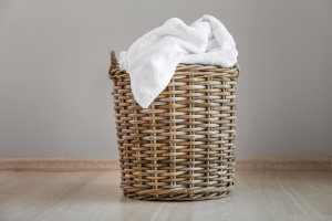 a wicker basket with piles of organic cotton towels 
