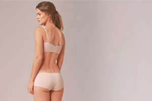 a woman wearing organic cotton underwear in pale pink 