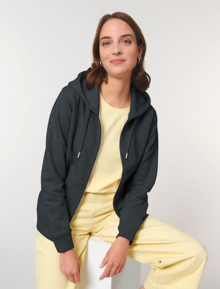 a man wearing an organic cotton zip up hoodie over a grey sweatshirt 