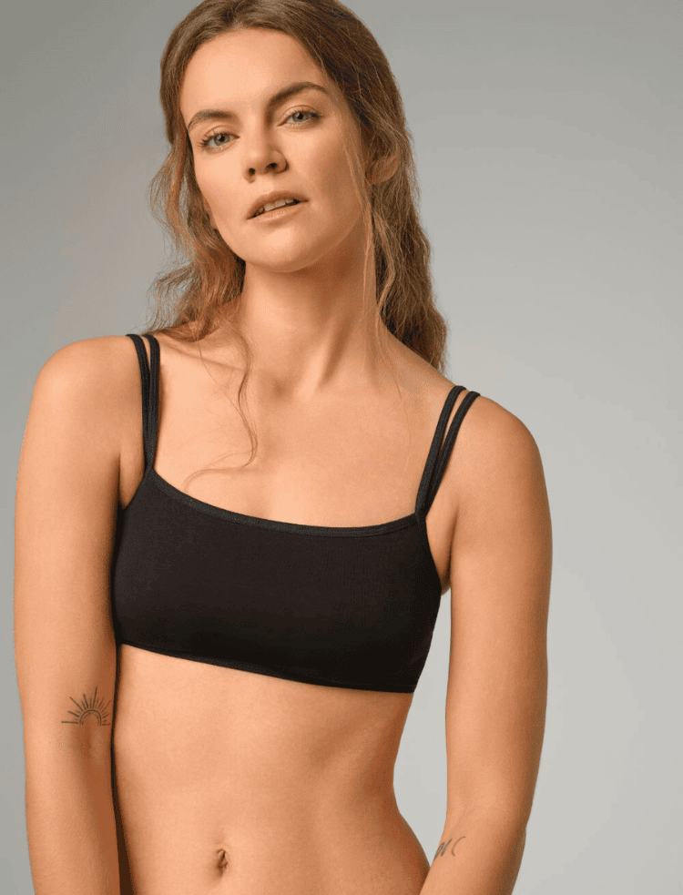 a woman wearing a black organic cotton bralette