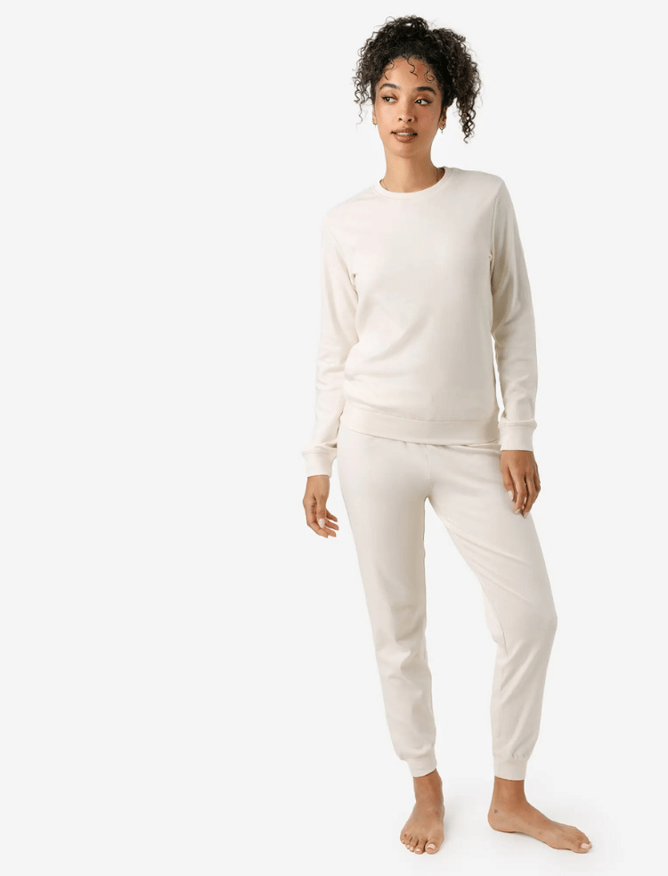 A woman is wearing ochre organic cotton pyjamas