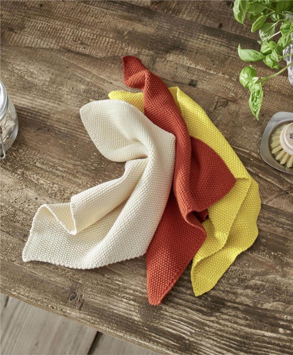 set of two organic knitted dish cloth in 3 colours turmeric yellow terracotta and natural undyed