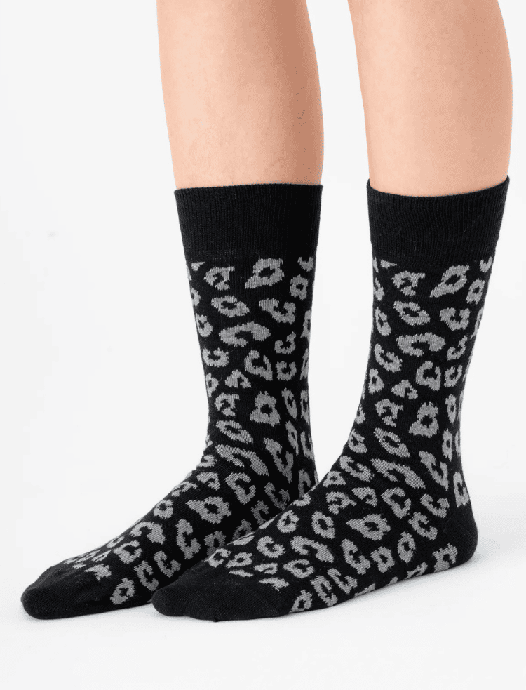 Legs wearing black and grey organic cotton leopard print socks