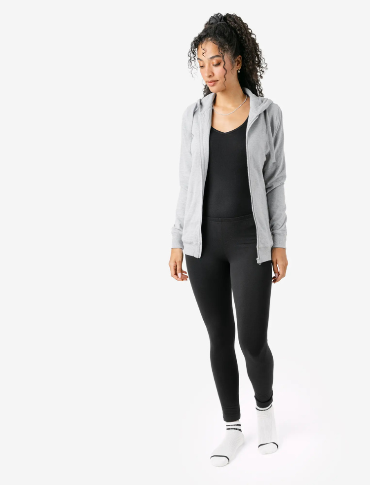 a woman is wearing indigo organic cotton warm leggings and a fleece top 