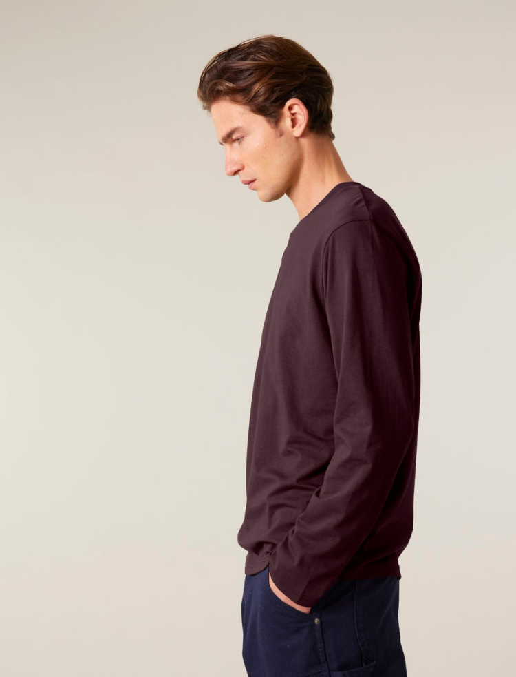 a man wearing a maroon organic cotton long sleeve t-shirt