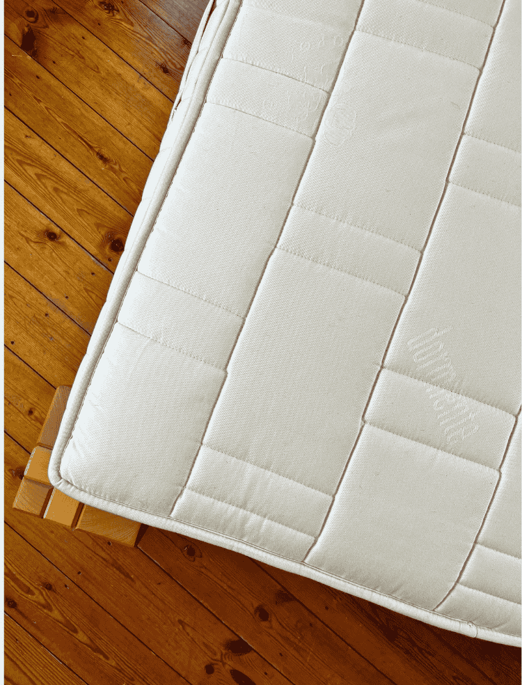 Natural latex flexi-cut mattress aeriel view on a wooden floor 