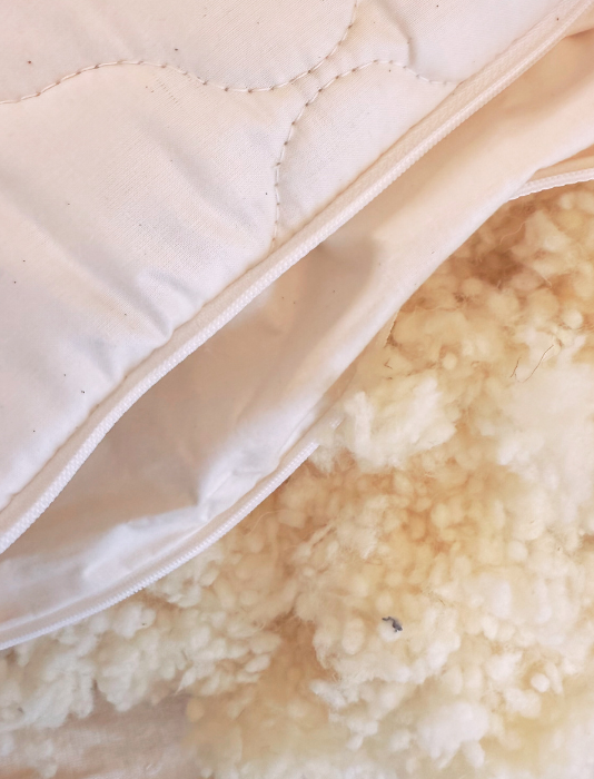 organic wool pillow with undyed natural organic cotton quilted cover with zip opening 