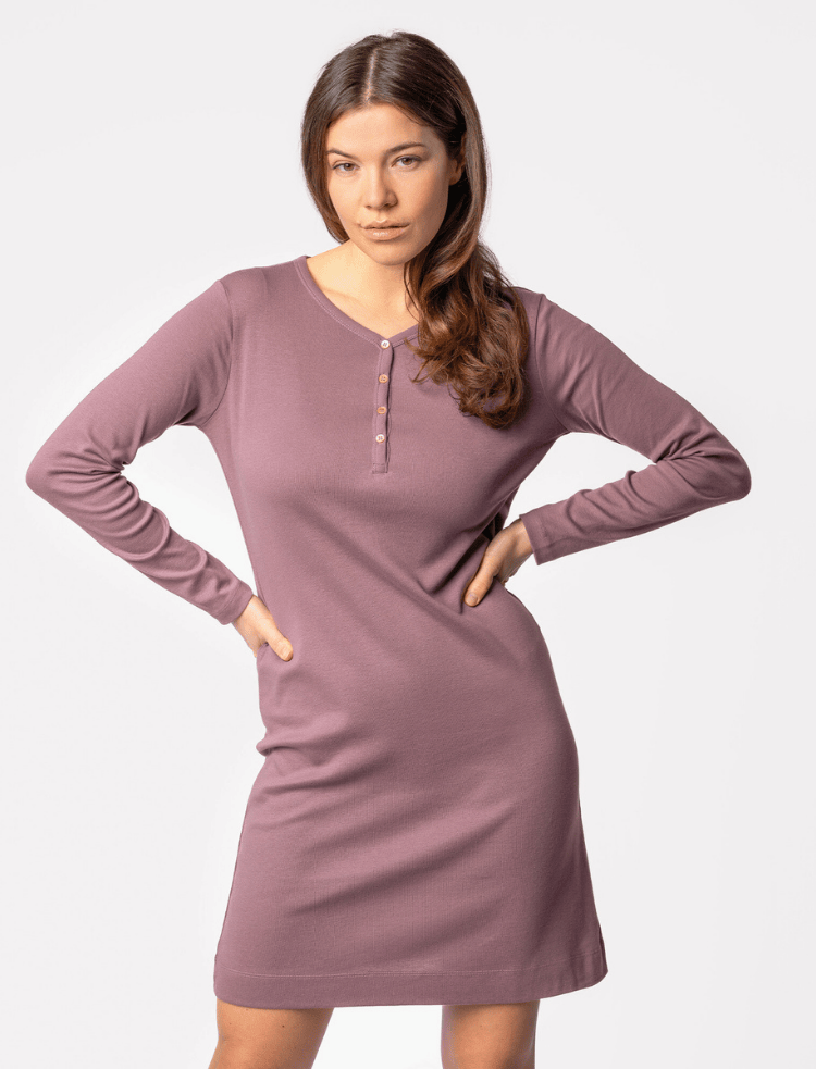 side view of a woman wearing a mauve organic cotton long sleeved night shirt with chunky knitted socks 