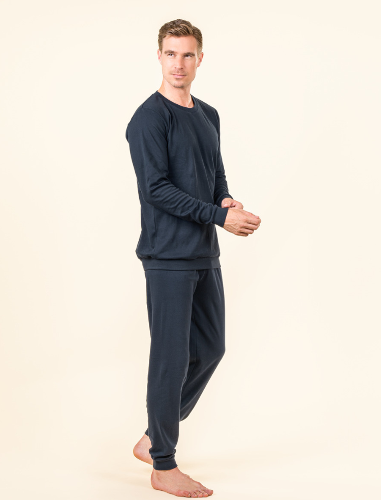 a man wearing navy blue organic cotton pyjamas 