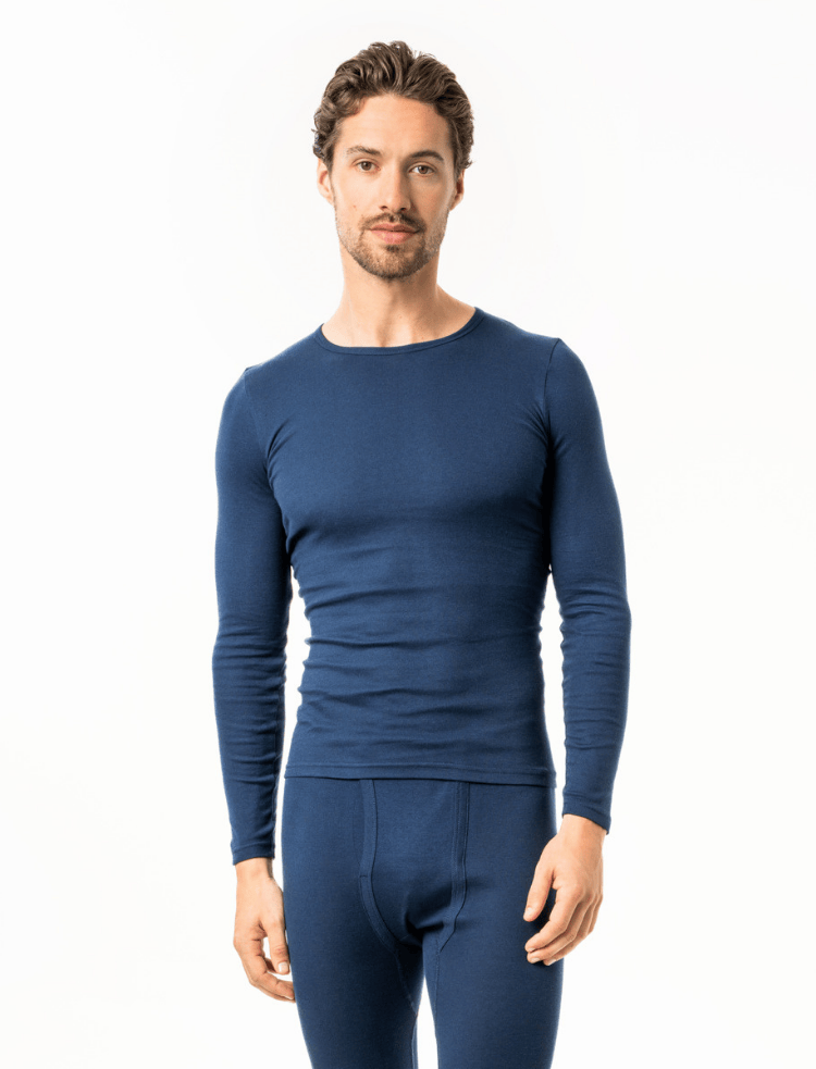 A man is wearing a navy organic cotton long sleeve vest 