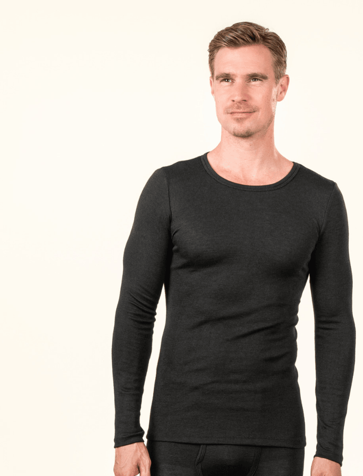 Man dressed in black long sleeve organic wool and silk vest