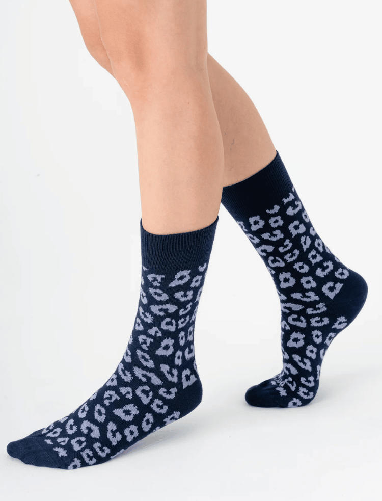 Legs wearing black and grey organic cotton leopard print socks