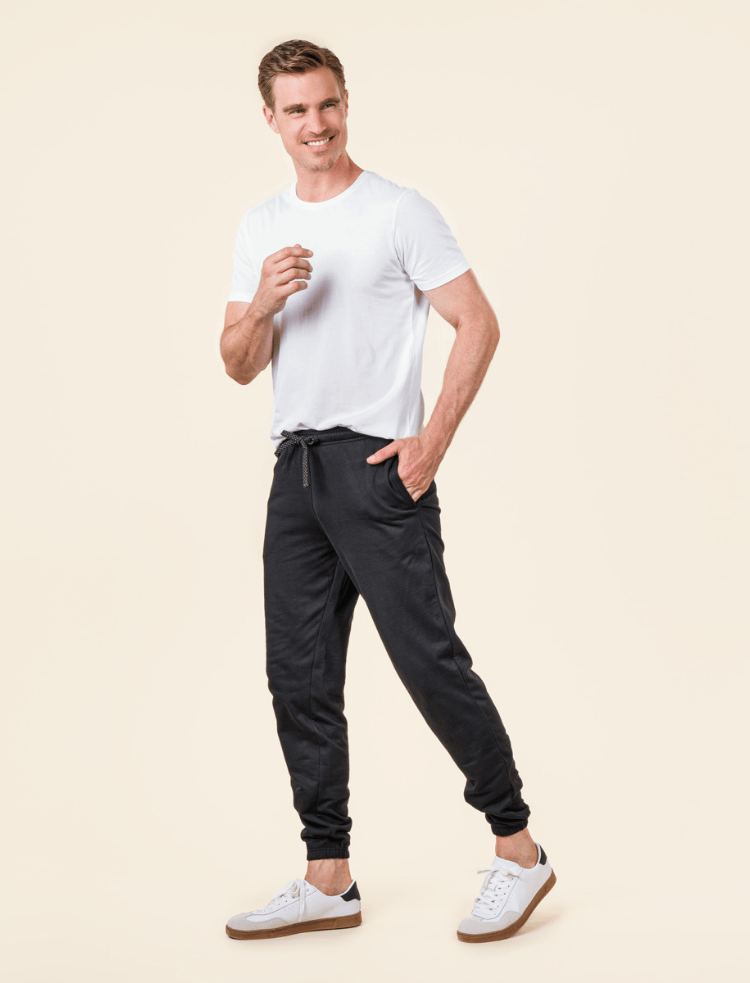 a man wearing organic cotton joggers in black