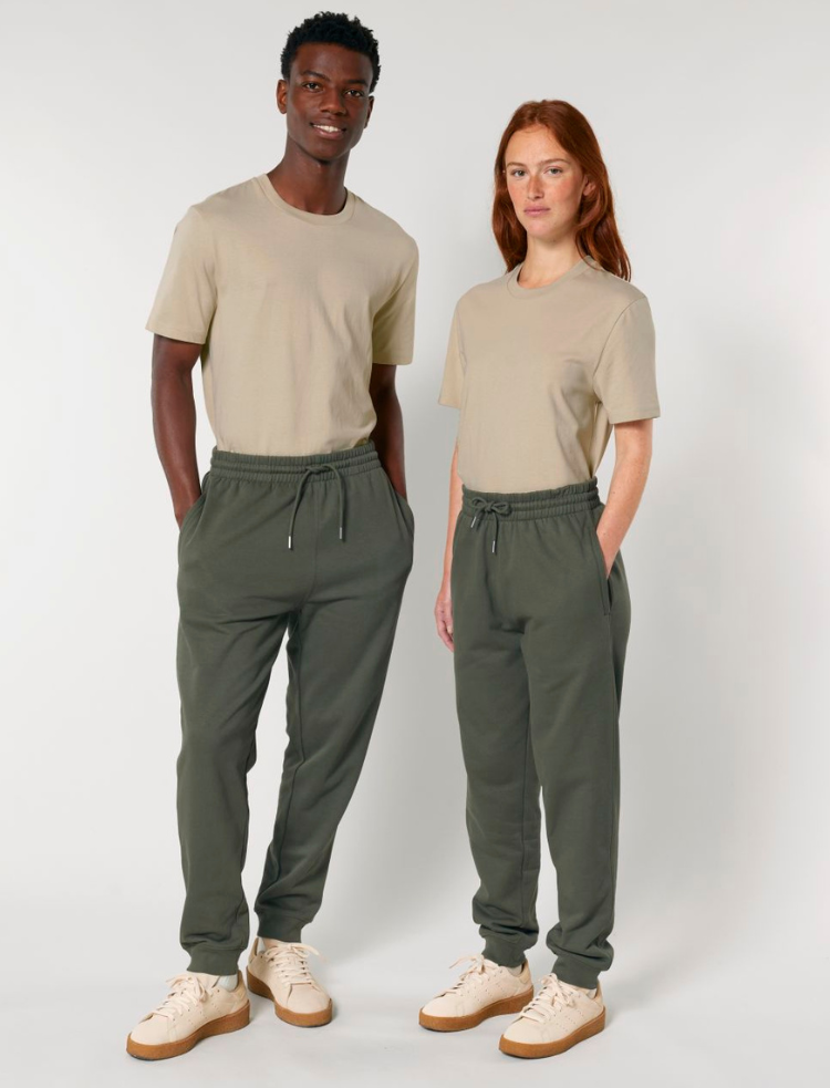 A man and a woman wearing olive organic cotton tapered jogging pants and organic cotton t-shirts 