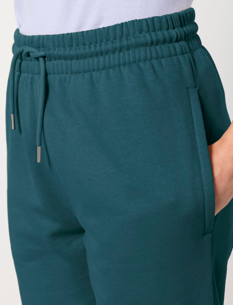 A man and a woman wearing olive organic cotton tapered jogging pants and organic cotton t-shirts 