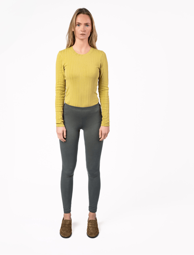 A woman wearing organic cotton burgundy leggings 