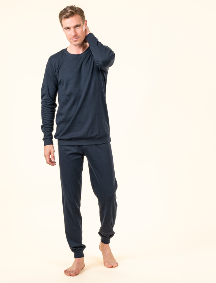 a man wearing navy blue organic cotton pyjamas 