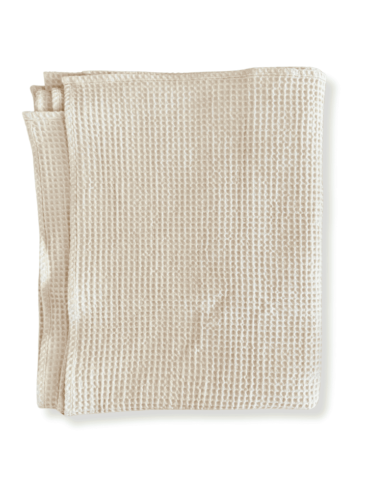 organic cotton waffle bath towel natural undyed creamy colour folded on a white background 