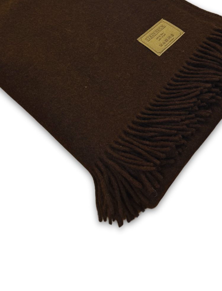 dark chocolate brown pure yak wool fringed blanket folded on a white background