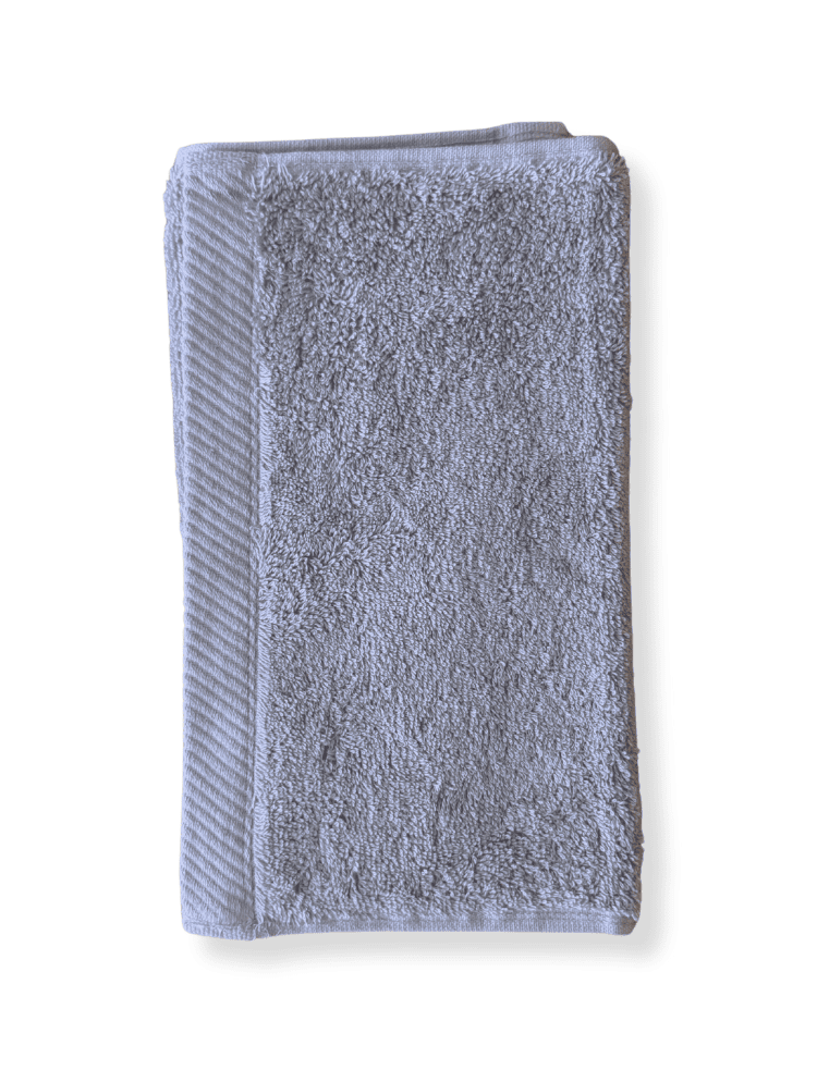 organic cotton guest towel in soft grey folded on a white background 