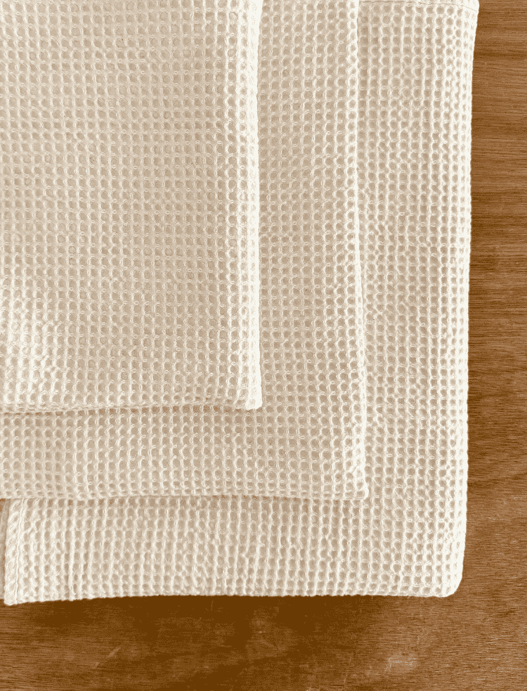 organic cotton waffle hand towel folded on a white background 