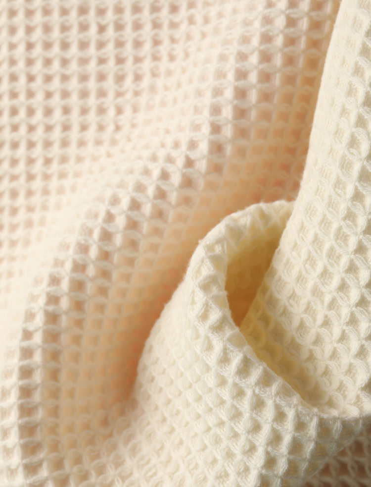 organic cotton waffle shower towel, undyed and unbleached natural colour folded 