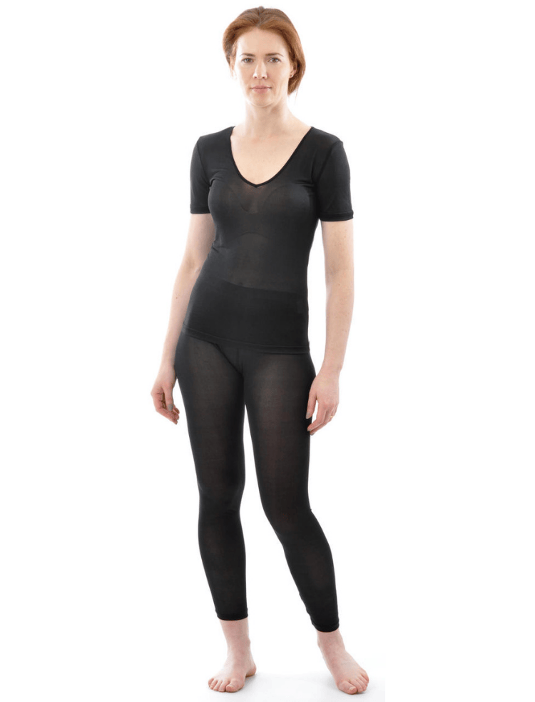 A woman is wearing black organic silk short sleeve vest and long johns 