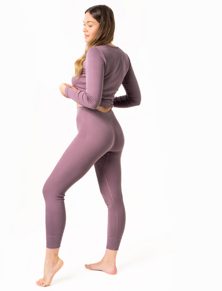 side view of a woman wearing organic cotton base layers in black 