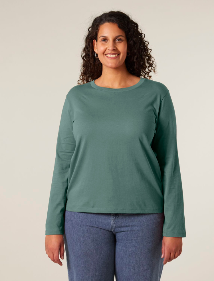 A woman is wearing an undyed long sleeve organic cotton t-shirt 