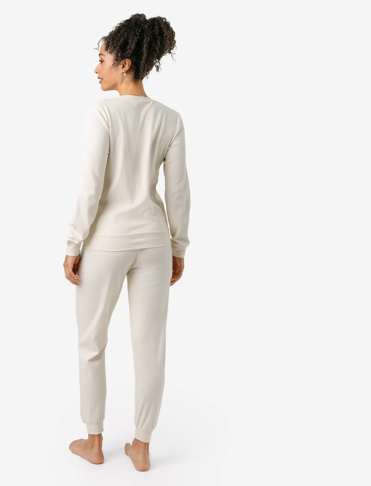A woman wearing organic cotton mauve coloured pyjamas 