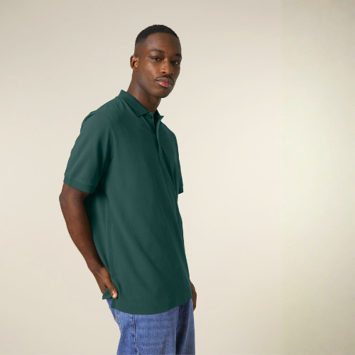 A man is wearing a green organic cotton polo shirt