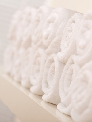 organic cotton towels rolled up and stacked on top of each other
