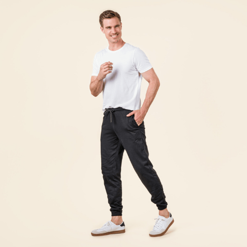 a man in a white organic cotton t-shirt and black organic cotton jogging bottoms