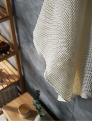 organic cotton waffle towel hanging in a bathroom